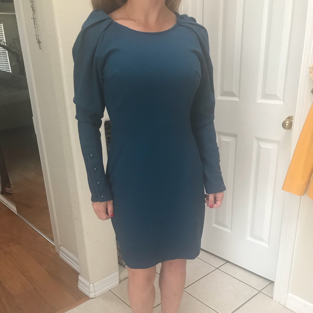 Gorgeous color dress with 80’s shoulders.